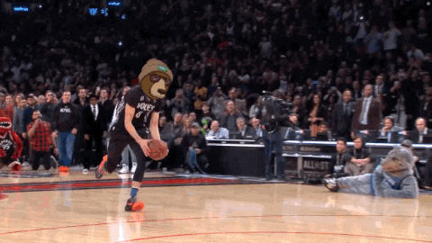 a basketball player wearing a holey jersey dribbles a basketball