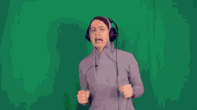 a man wearing headphones with a green background