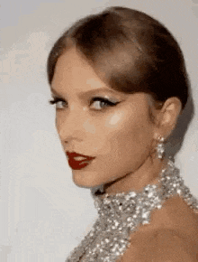 a close up of a woman 's face wearing a choker and earrings .