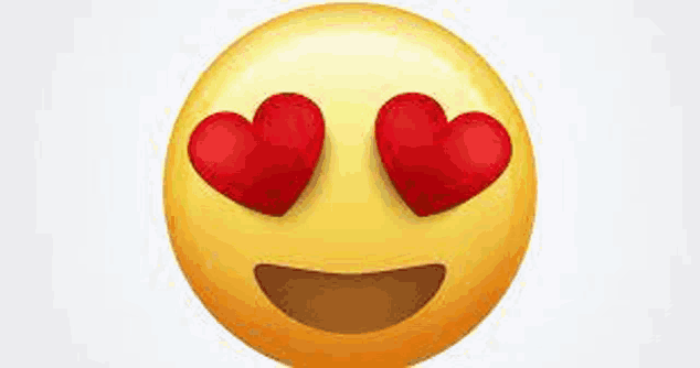 a yellow smiley face with red heart shaped eyes .