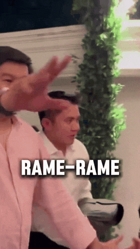 a man in a pink shirt says " rame-rame " in front of two other men