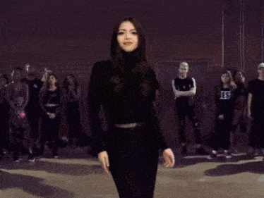 a girl wearing a black shirt that says js is surrounded by fire