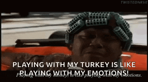 a man with curlers in his hair is sitting in a car and playing with his turkey is like playing with his emotions
