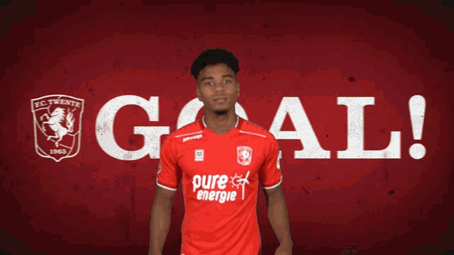 a man in a red shirt with the word pure energie on it