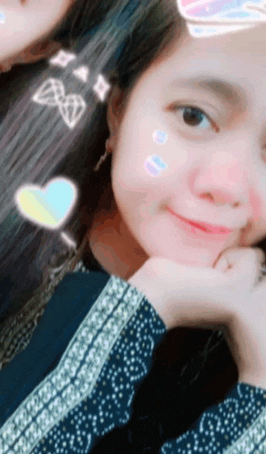 a girl with a heart on her hair is smiling