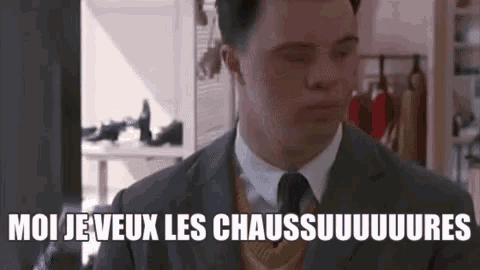 a man in a suit and tie is saying `` moi je veux les chaussures '' in french .