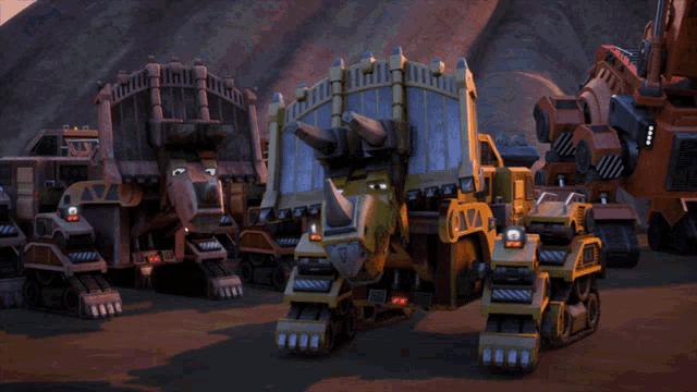 a group of toy vehicles including a triceratops and a rhinoceros are lined up in a field