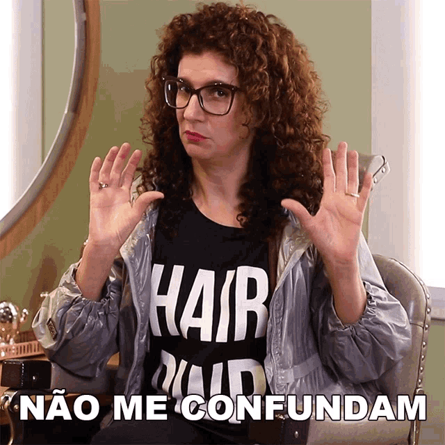 a woman with curly hair is wearing a shirt that says " hair " on it