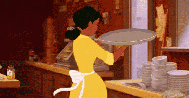 a woman in a yellow dress is holding a tray in her hand