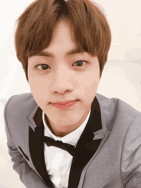 a young man in a tuxedo with a bow tie