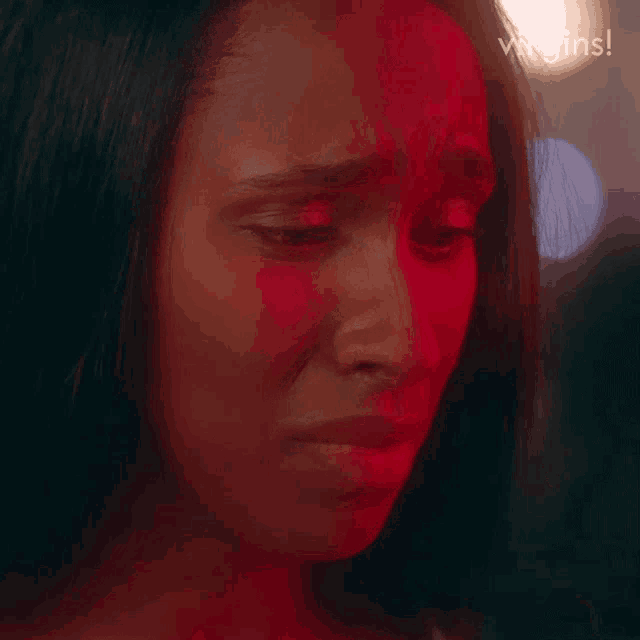 a close up of a woman 's face with a red background and the words virgins written on the bottom