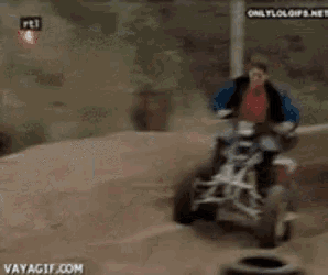 a man is riding a four wheeled vehicle on a dirt road