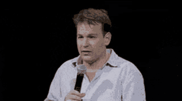 a man speaking into a microphone with the words i don t think that 's true behind him