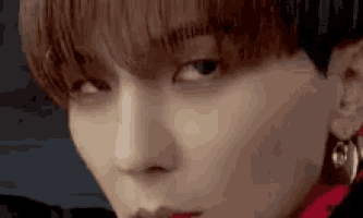 a close up of a person 's face with a piercing in their nose .