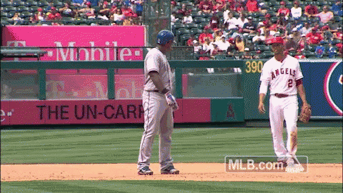 a baseball player with the number 2 on his jersey talks to another player