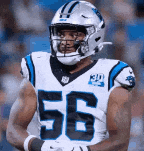 a football player wearing a helmet and number 56 on his jersey .