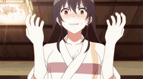 a girl in a kimono is making a funny face and holding her hands up .