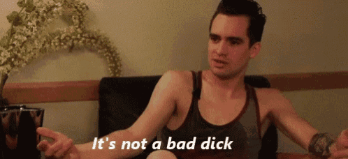 a man in a tank top is sitting on a couch and says " it 's not a bad dick "