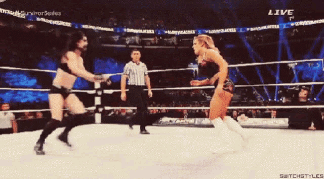a man and a woman are wrestling in a ring with the words live on the bottom right