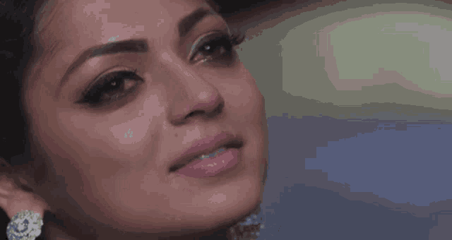 a close up of a woman 's face with a tear running down her face .