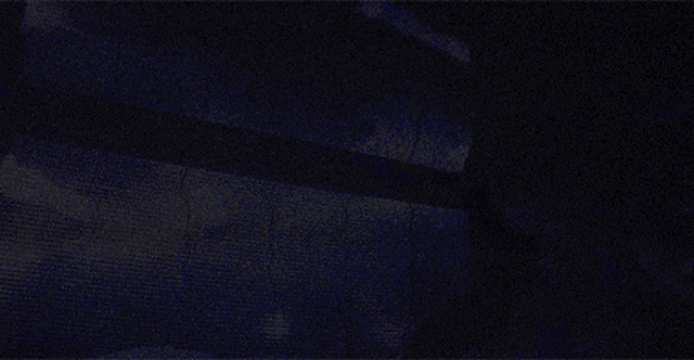 a person is standing in front of a screen with a galaxy projected on it