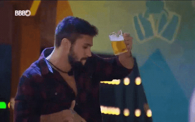 a man in a plaid shirt is holding a glass of beer with the letters bbbo on the bottom right