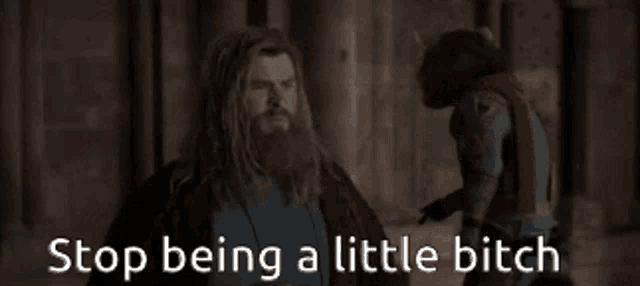 a man with a beard is standing next to a woman with the words stop being a little bitch written below him .