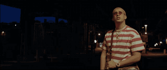 a man wearing a red and white striped shirt and sunglasses