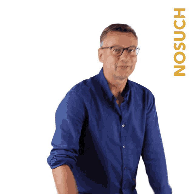 a man wearing glasses and a blue shirt stands in front of a white background with the word nosuch written on it