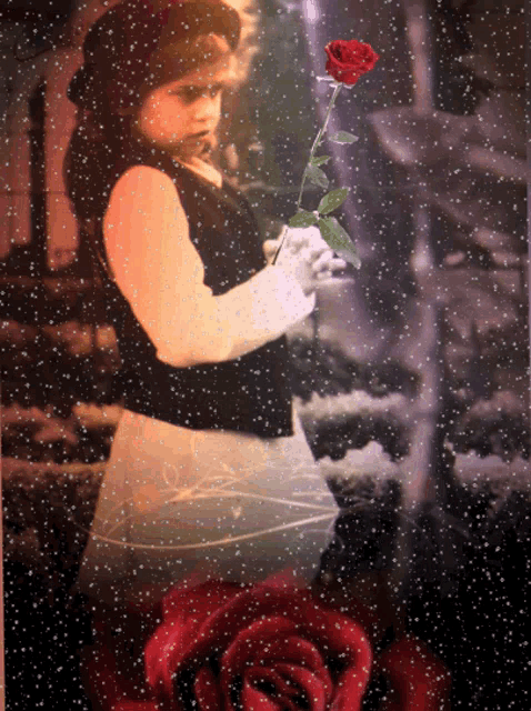 a little girl in a black top and white gloves holds a red rose