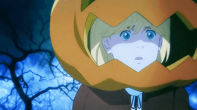 a girl with a pumpkin on her head is looking at the camera