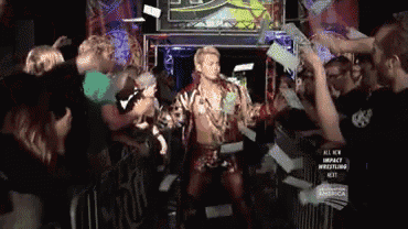 a man in a wrestling ring with a sign that says all new impact wrestling next on it