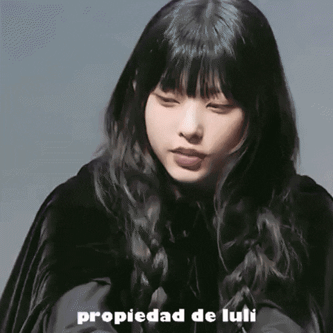 a close up of a woman 's face with the words propiedad de luli written below her