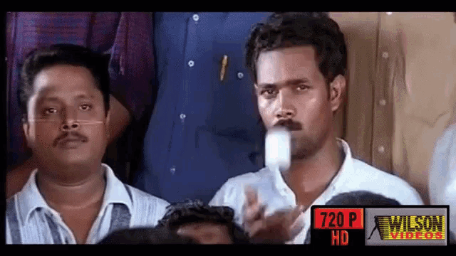 a group of men are sitting in front of a 720p wilson video