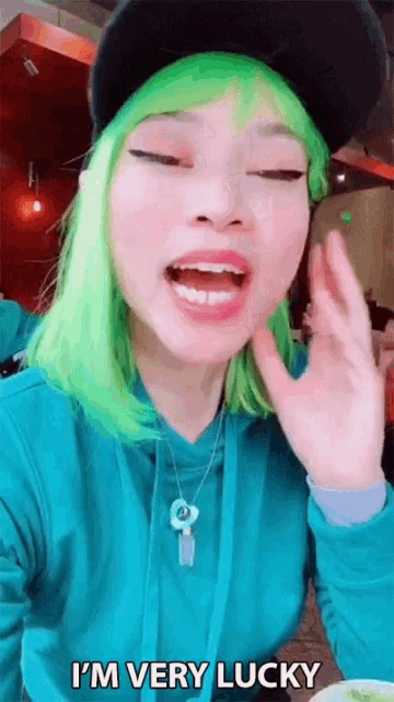 a woman with green hair and a hat says i 'm very lucky .