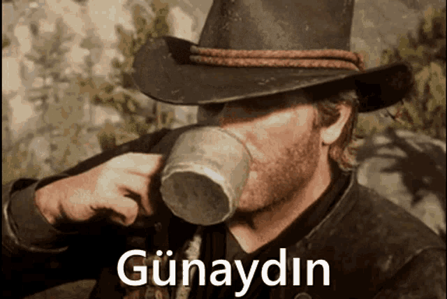 a man in a cowboy hat is drinking from a cup with the word günaydin written on the bottom