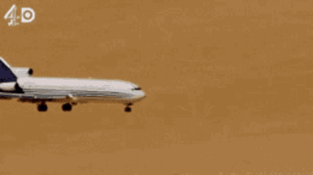 an airplane is taking off from a desert runway and the letters 4d are visible