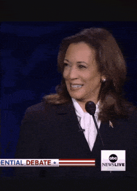 a woman is smiling in front of an abc news live headline
