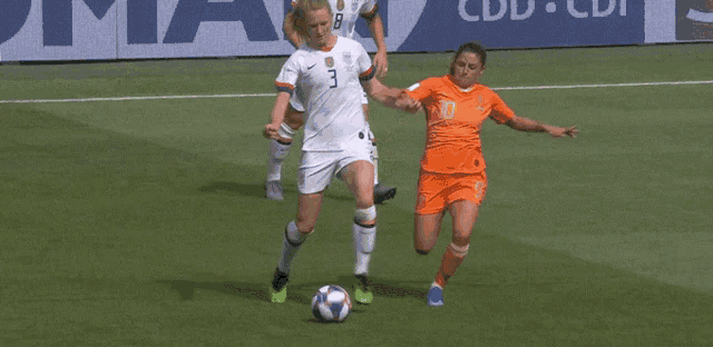 a soccer player with the number 3 on her jersey is dribbling the ball