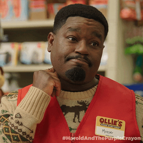 a man wearing a red vest that says ollie 's moose on it