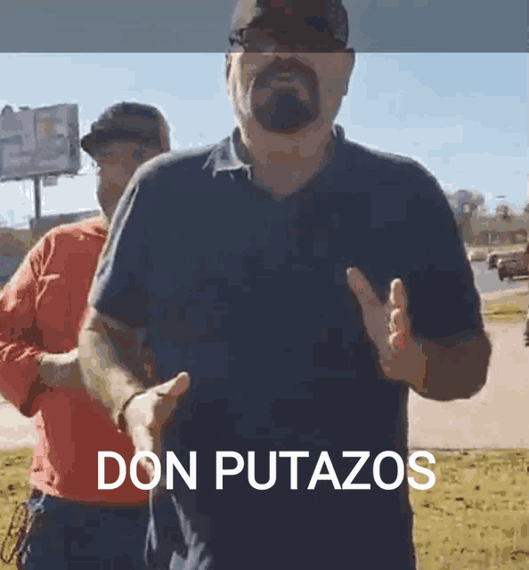 a man giving a thumbs up in front of a sign that says " don putazos "