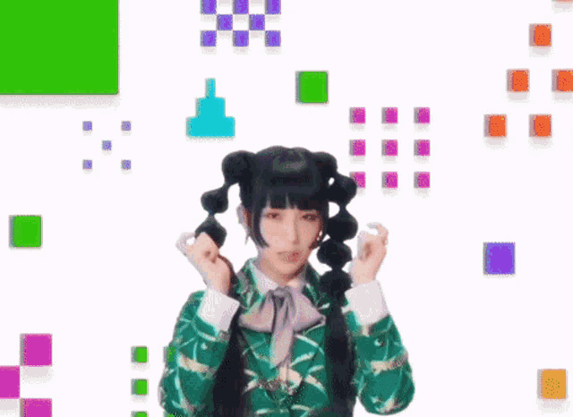 a girl with pigtails is crying with her eyes closed while holding a piece of paper to her face .