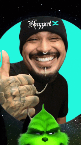 a man wearing a beanie that says blizzard x is smiling and giving a thumbs up