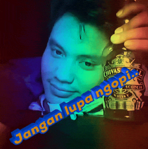 a man holding a bottle of chivas scotch whisky