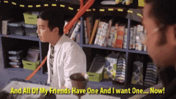 a man in a white shirt and tie says " and all of my friends have one and i want one ... now "