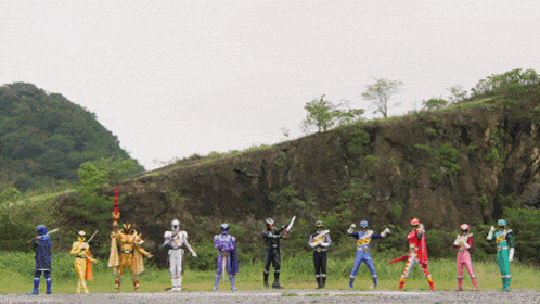 a group of power rangers standing next to each other on a dirt road
