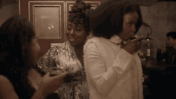 a group of women are standing next to each other in a room .