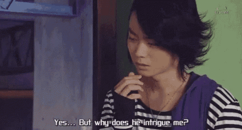 a man in a striped shirt is talking to someone and says " yes but why does he intrigue me "