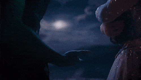 a man and a woman hold hands in the dark