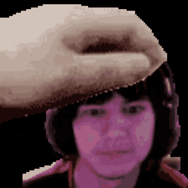 a pixelated image of a person 's head with a hand reaching for it